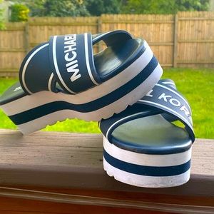 Michael Kor’s logo wedge slip-on sandals